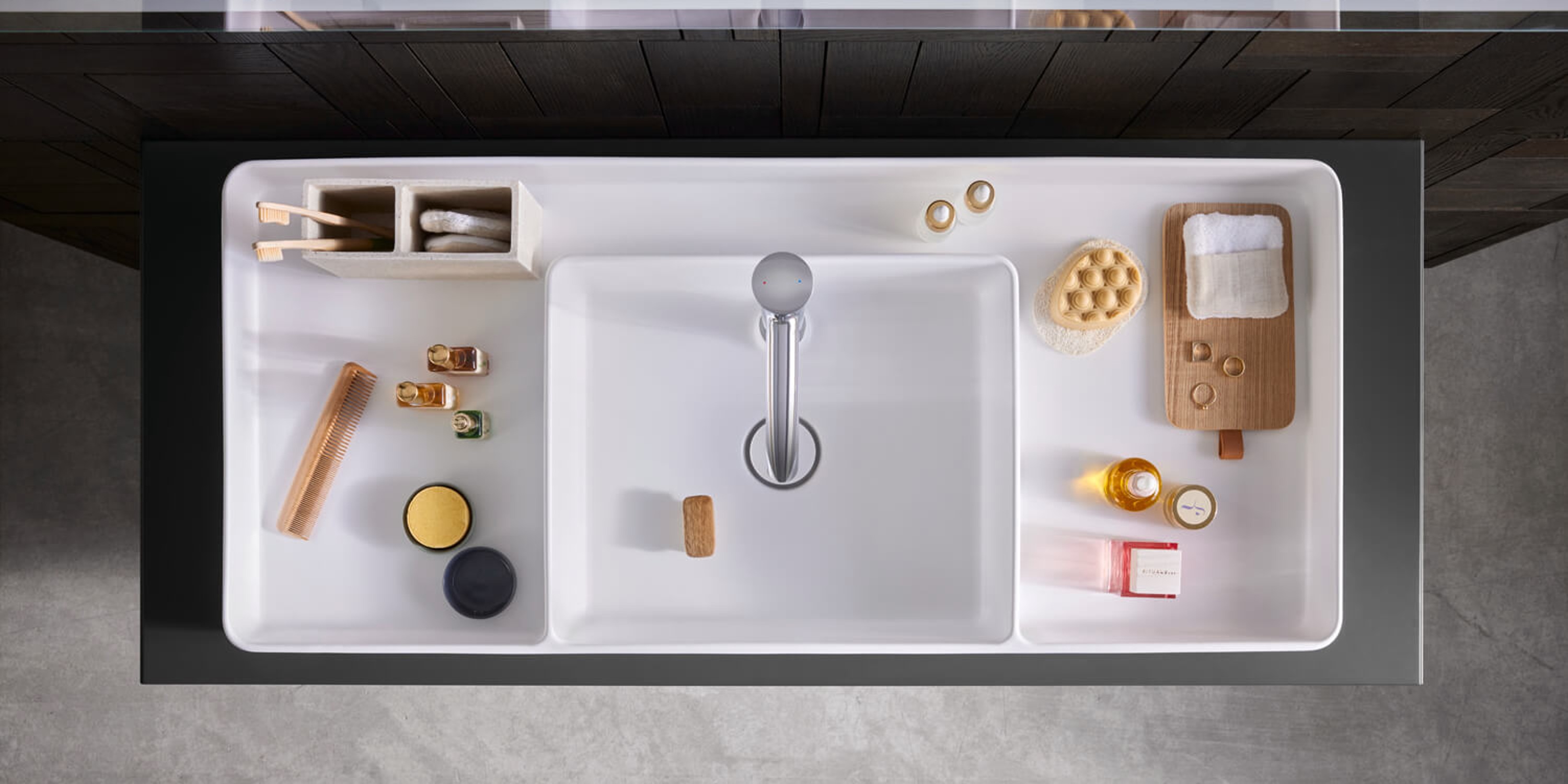Duravit Bento Starck Box countertop sink filled with colorful accessories, viewed from above