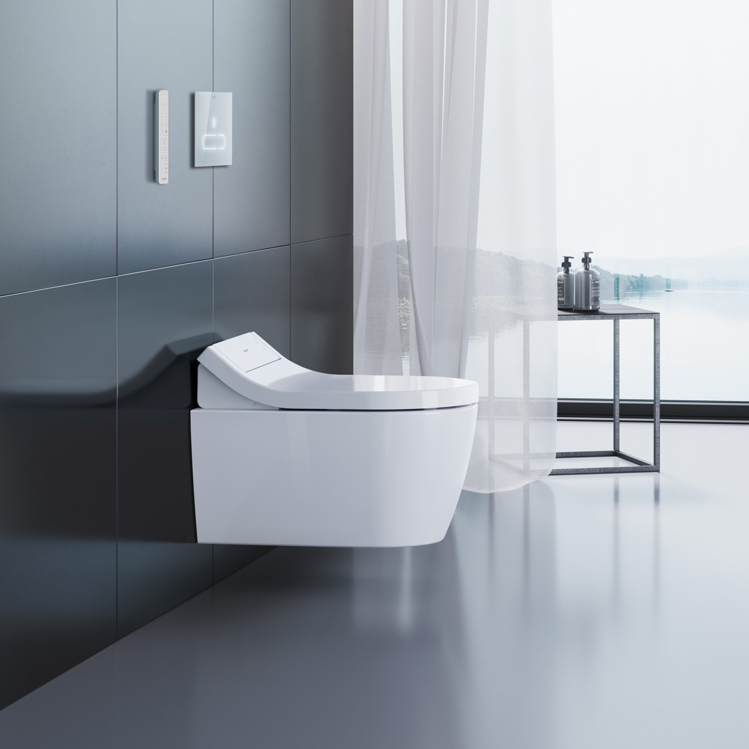 A white shower toilet hangs on a dark tiled wall. In the background, there is a window, a side table, and a curtain.