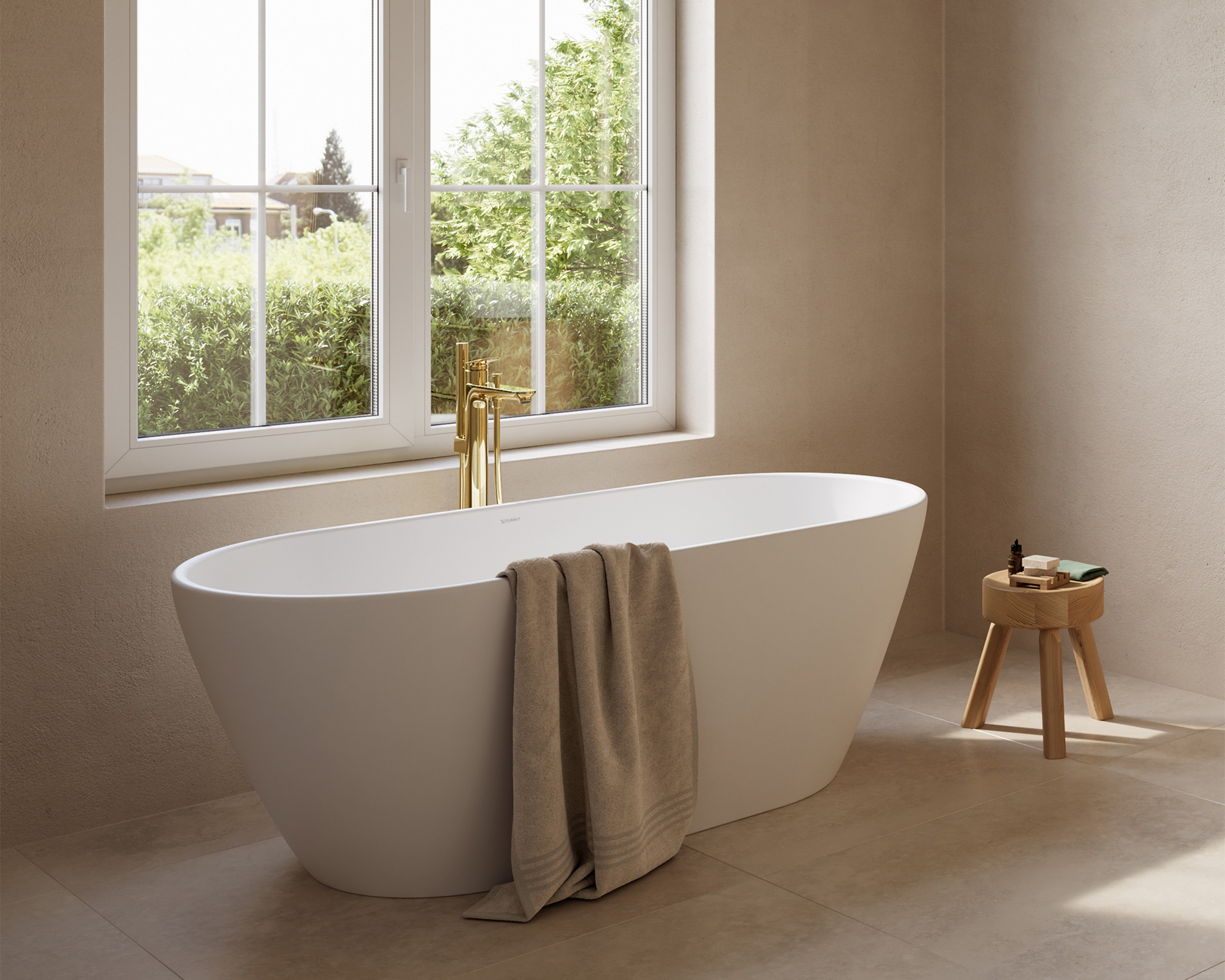Golden faucets from the Duravit Wave series on a bathtub