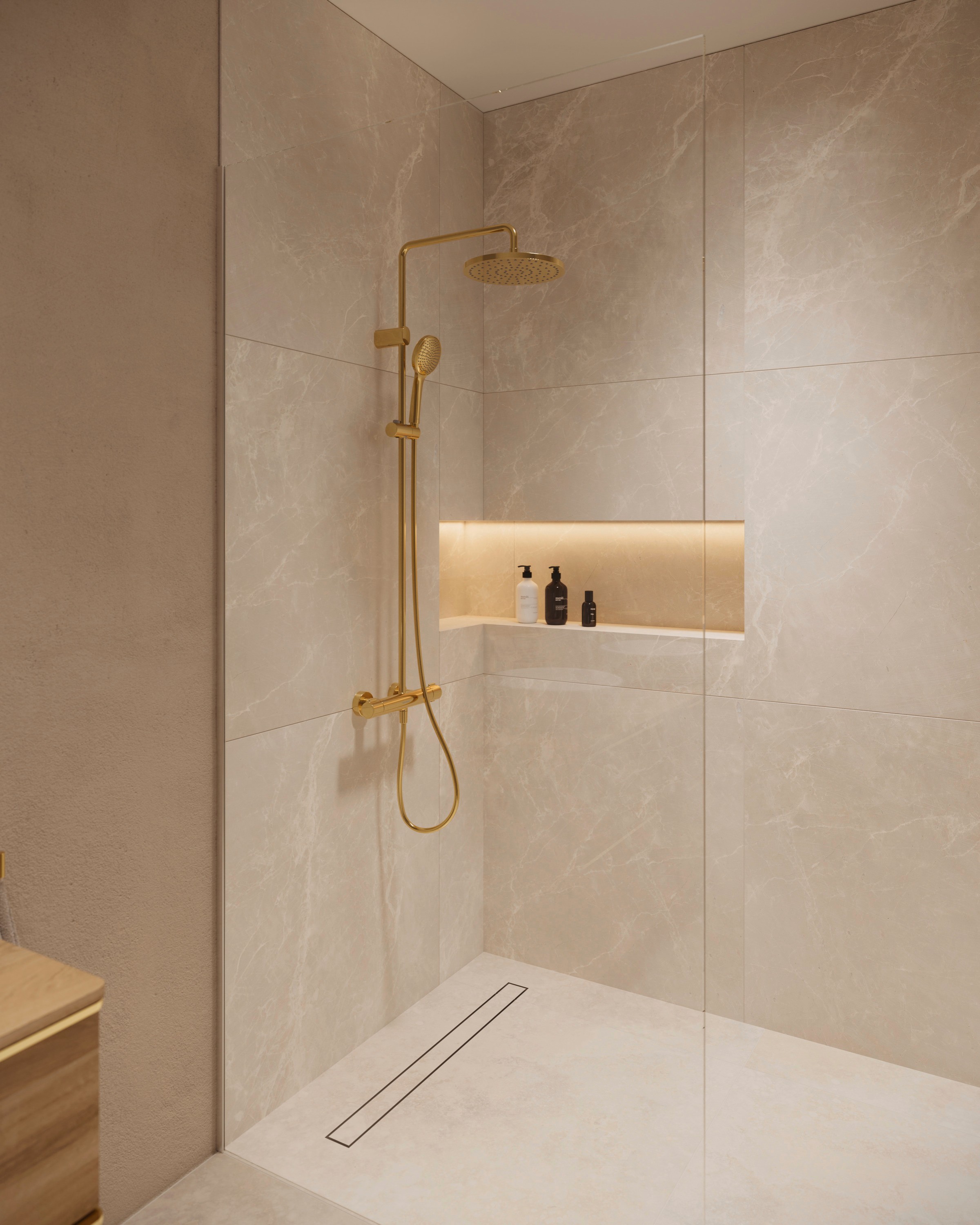 Shower system from the Duravit Wave series and a hand shower in polished gold