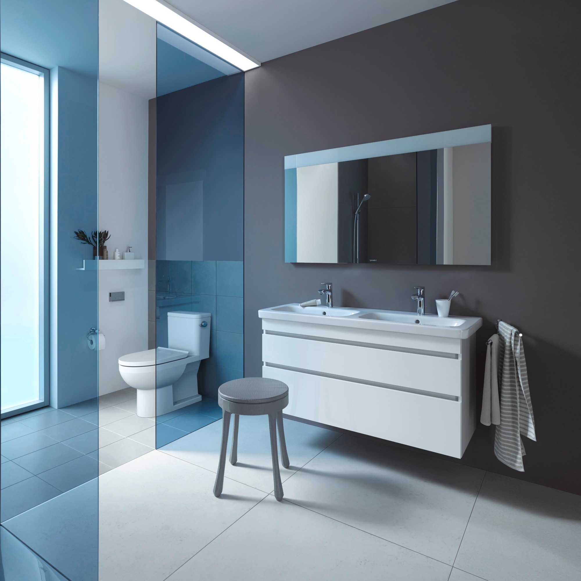 Sink area with Duravit DuraStyle double sink and white vanity unit against a gray wall, a floor-standing toilet next to it