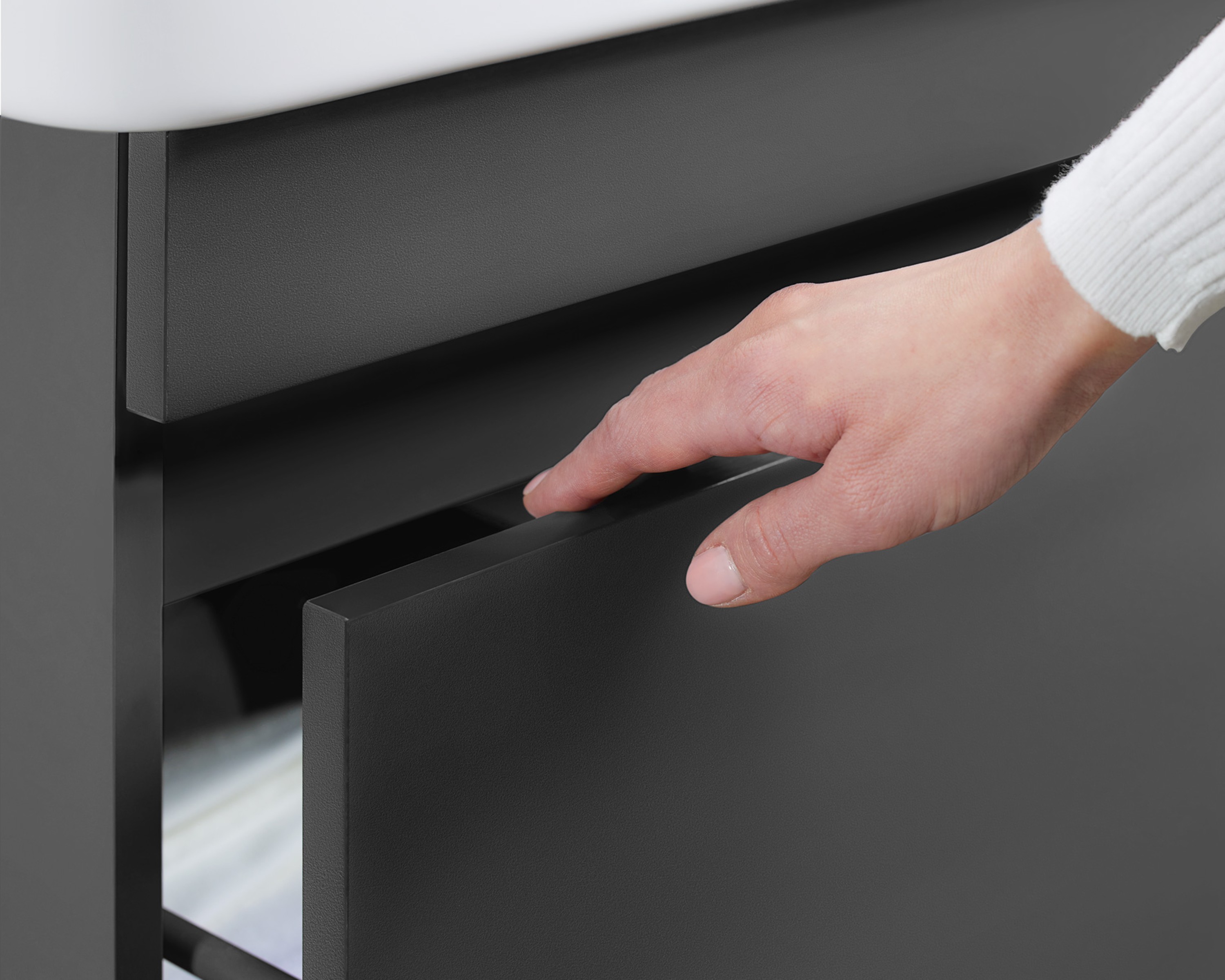 Hand opening a base cabinet from the Duravit DuraStyle series