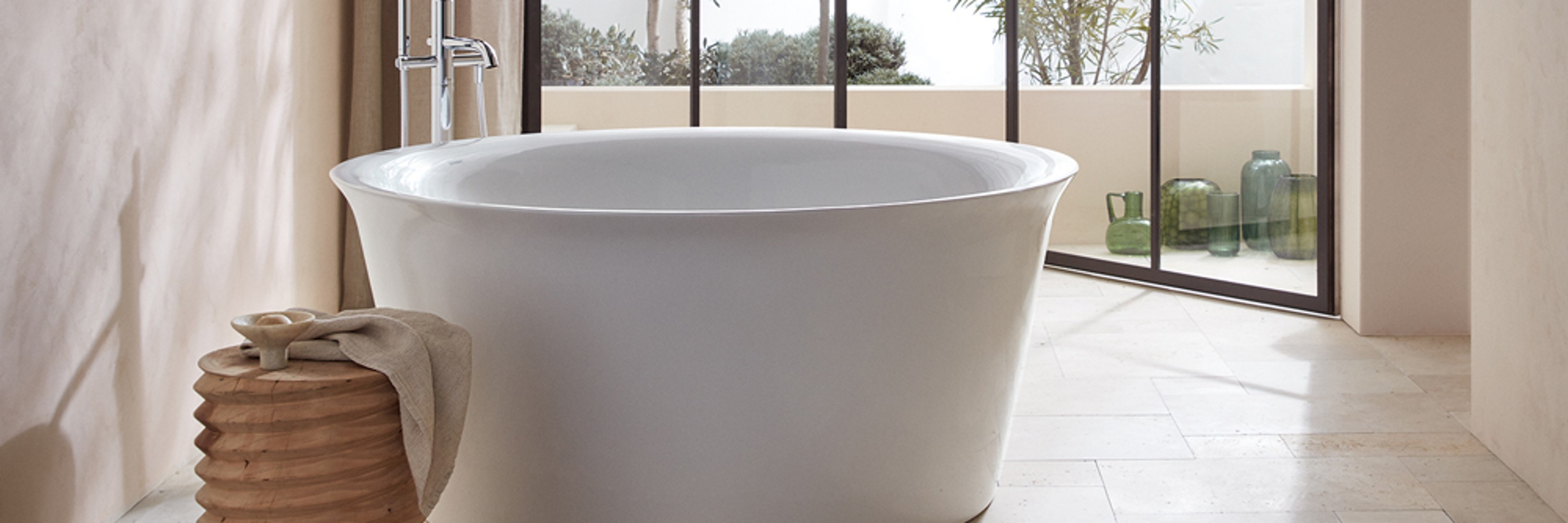 Duravit White Tulip freestanding bathtub in a bright bathroom with floor-to-ceiling windows
