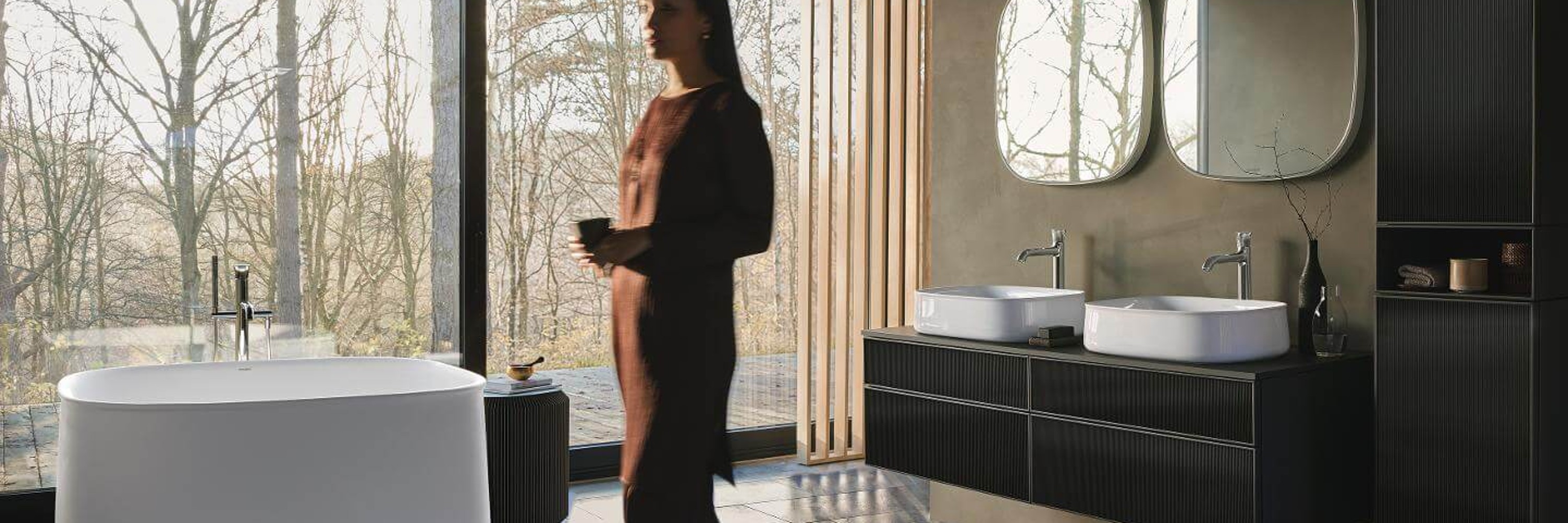 Woman in a bathroom with a Zencha Bathtub and furniture