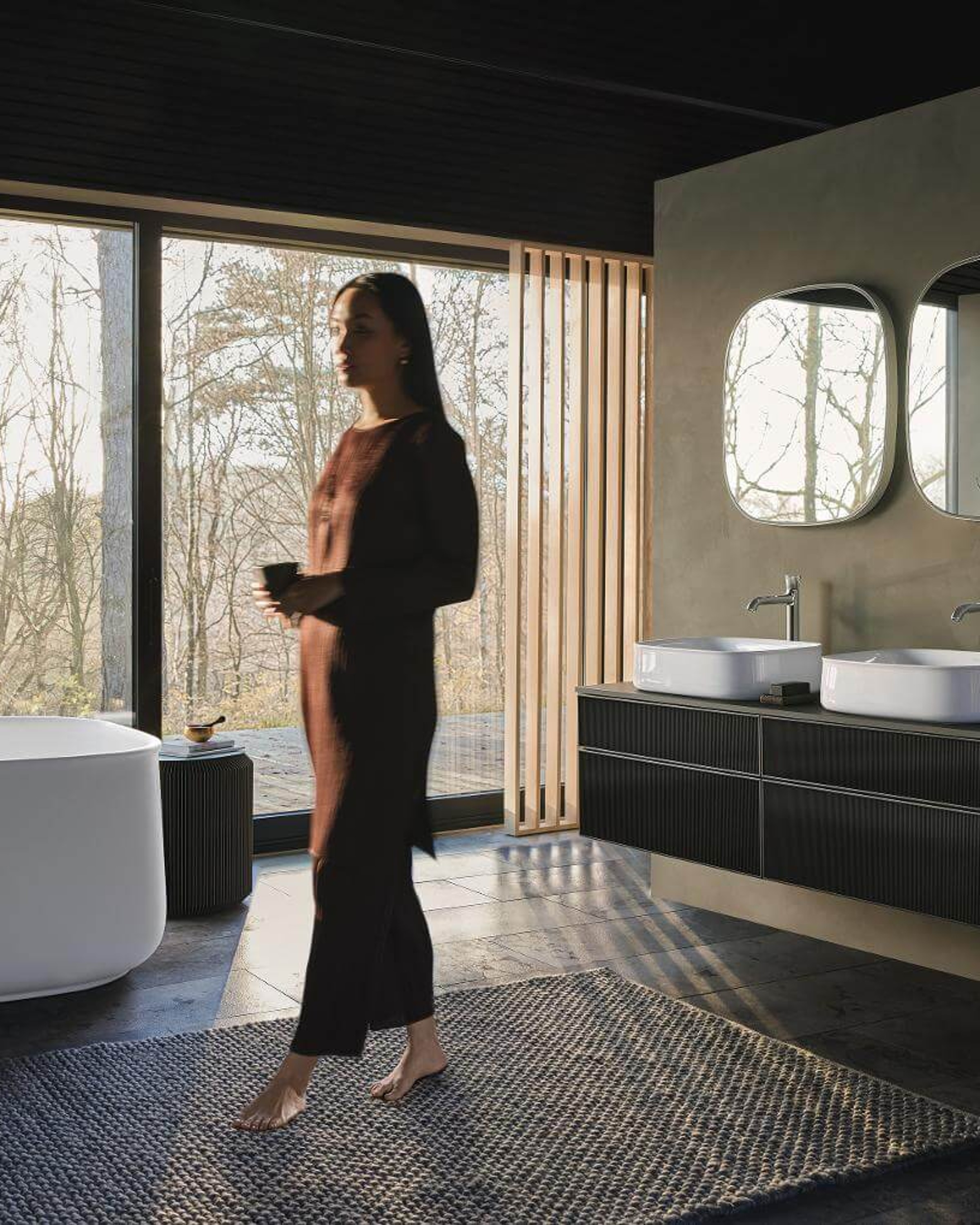 Woman in bathroom with Zencha bathtub and furniture