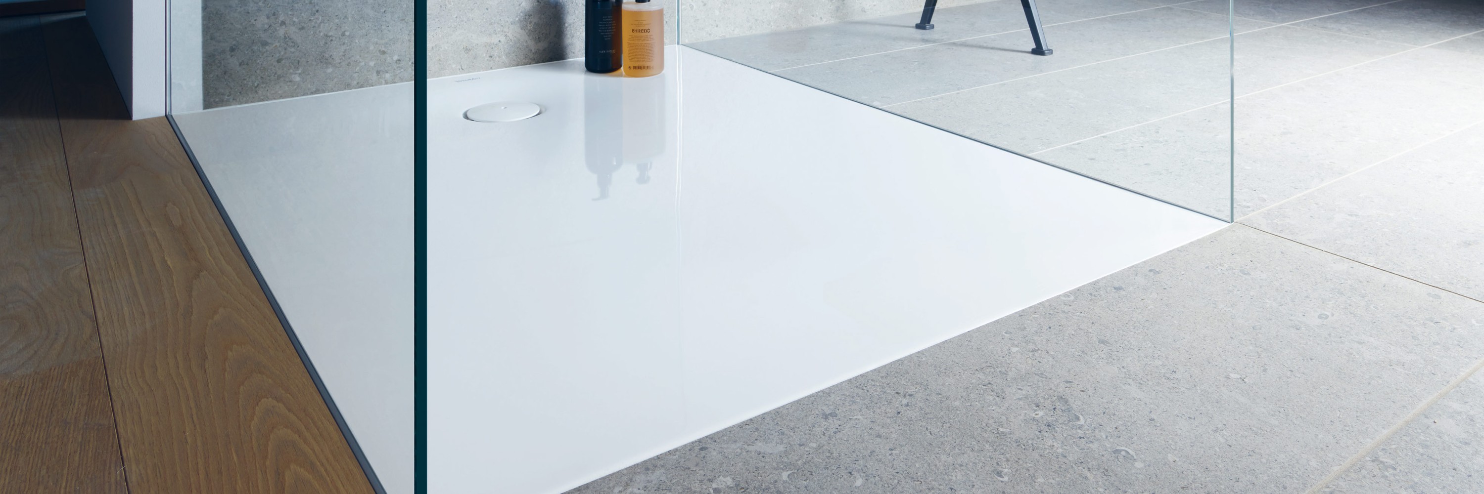 A floor-level or walk-in shower with two glass walls