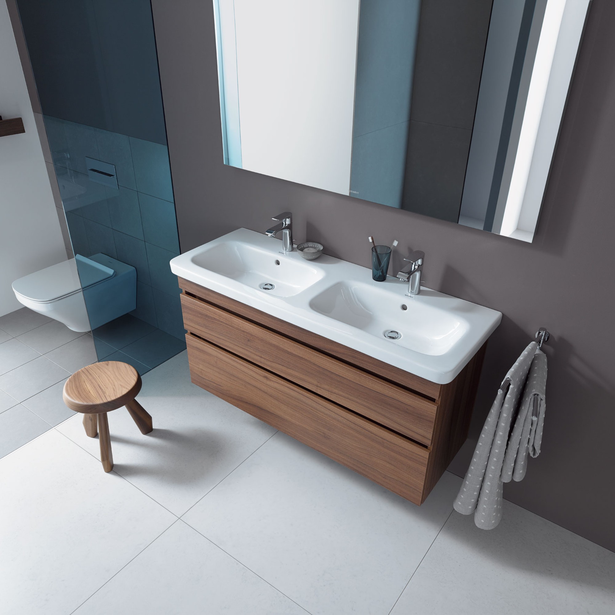 Sink area with Duravit DuraStyle double sink and vanity unit in front of a large mirror, with a toilet next to it