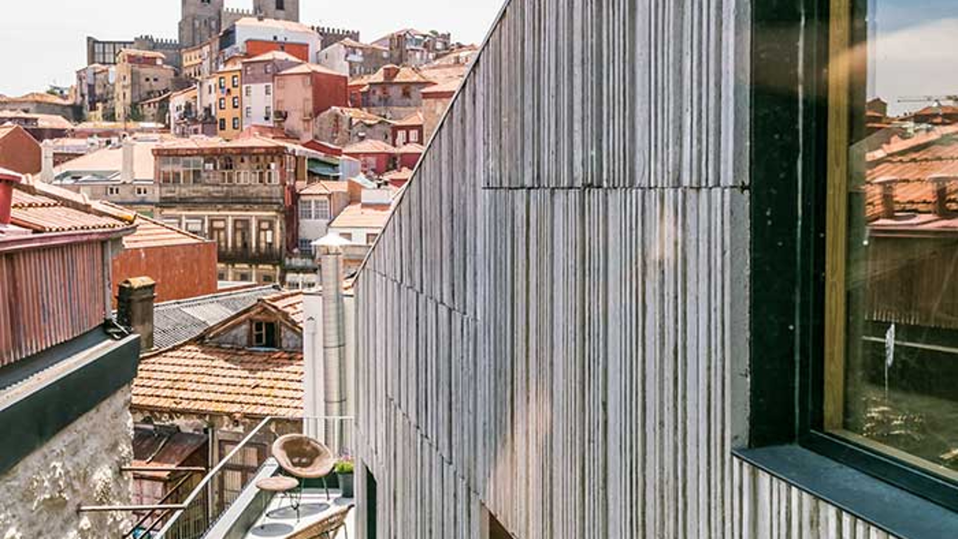 Armazem Luxury Housing exterior view of the building with balcony and view of the city