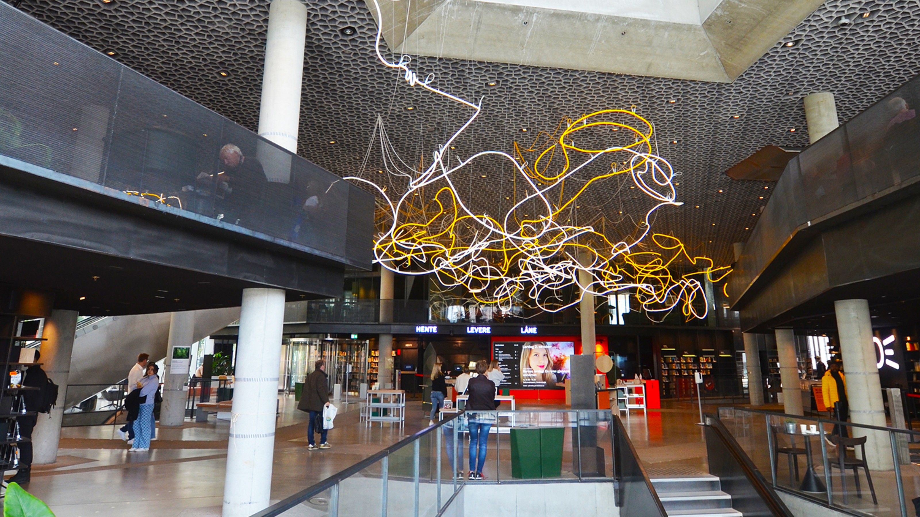 Deichman Library Oslo, interior view of the building with visitors, entrance area