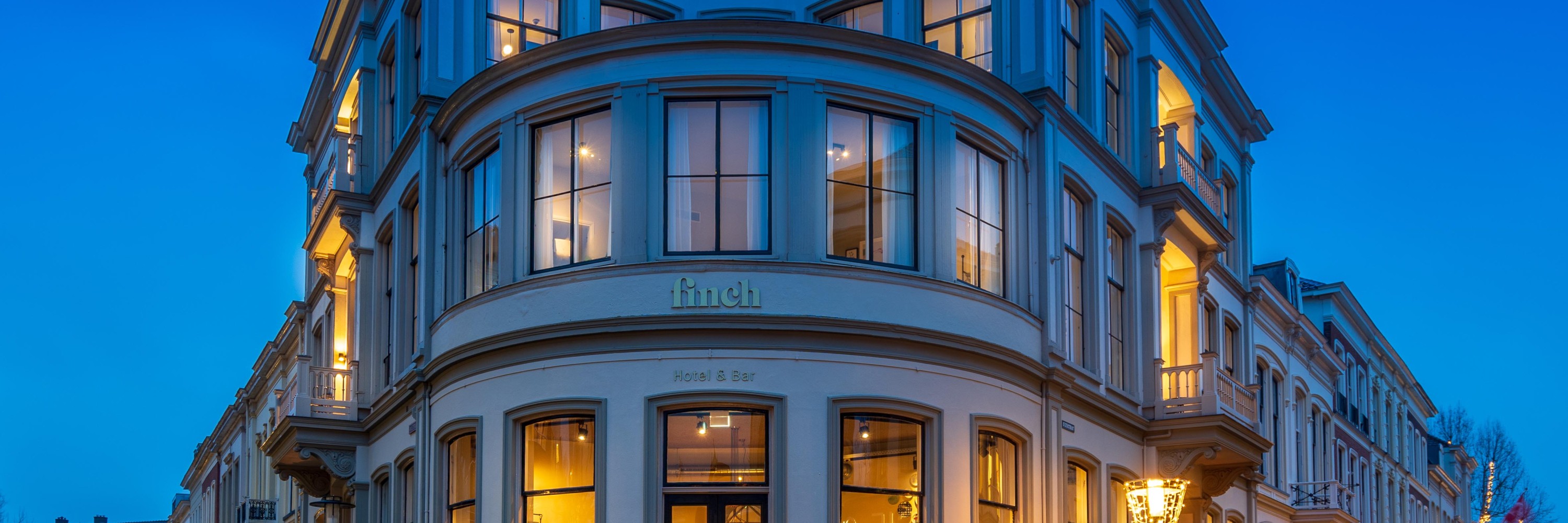 FINCH Boutique Hotel, illuminated building from the outside at dusk