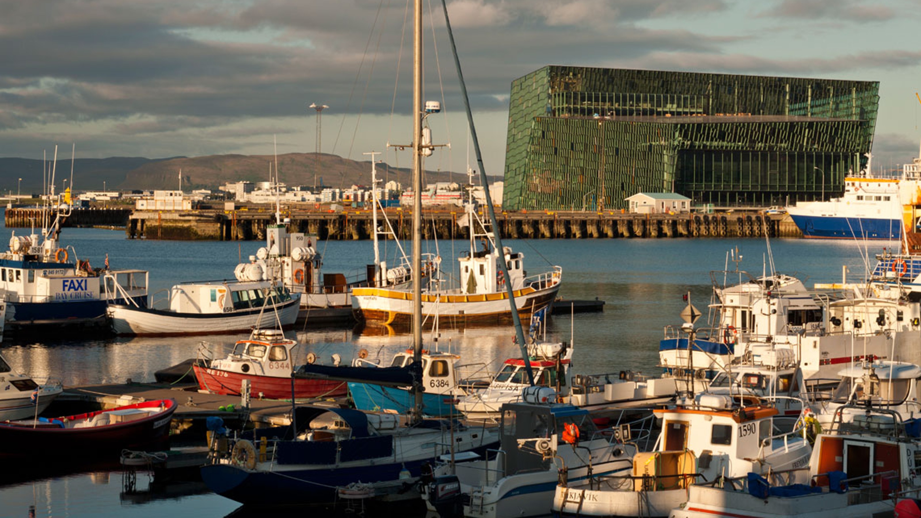 Harpa Concert Hall, view of the building from the harbour, with boats in the foreground