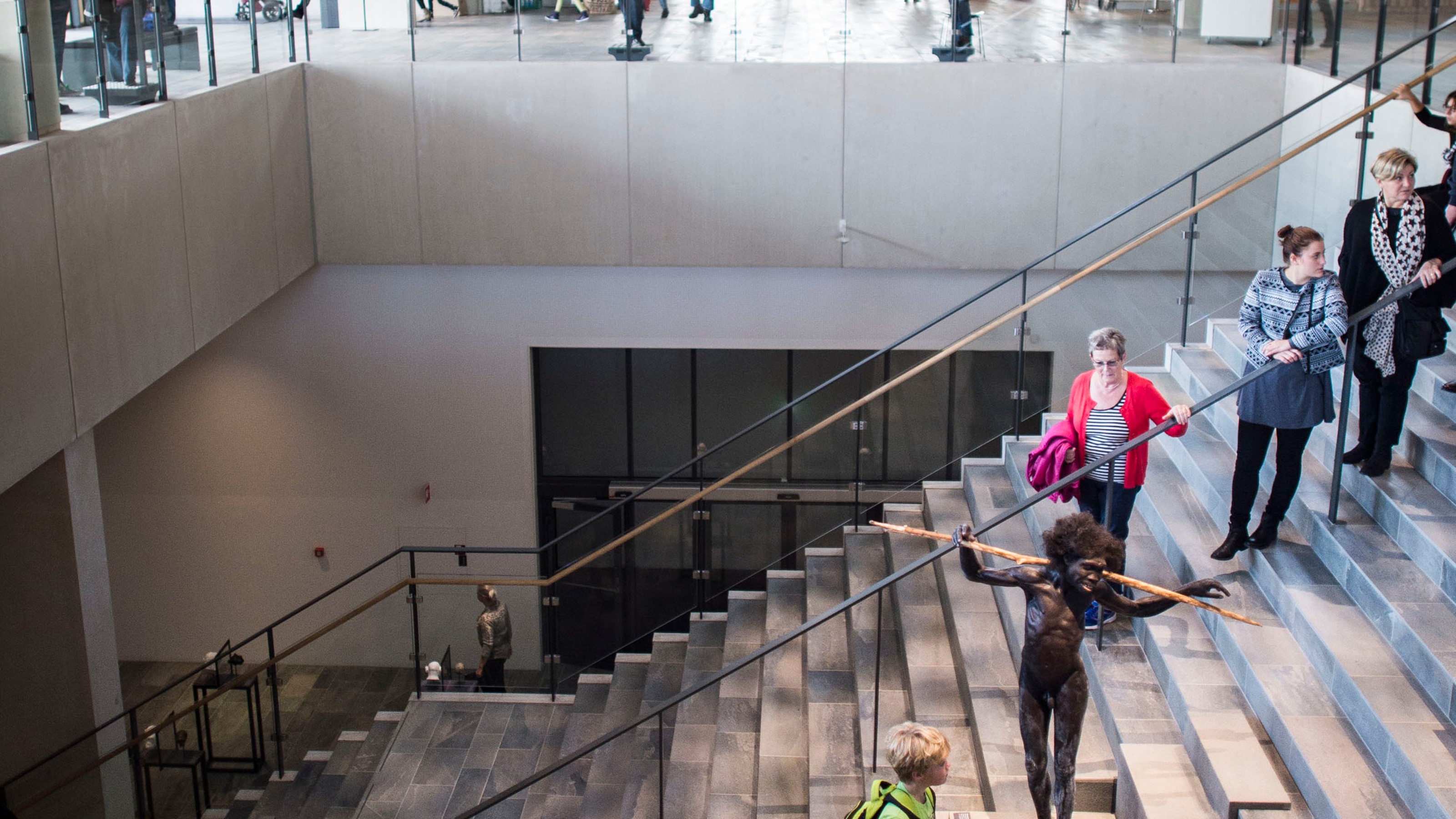 Moesgard Museum, view from inside with a large number of visitors, staircase in the foreground