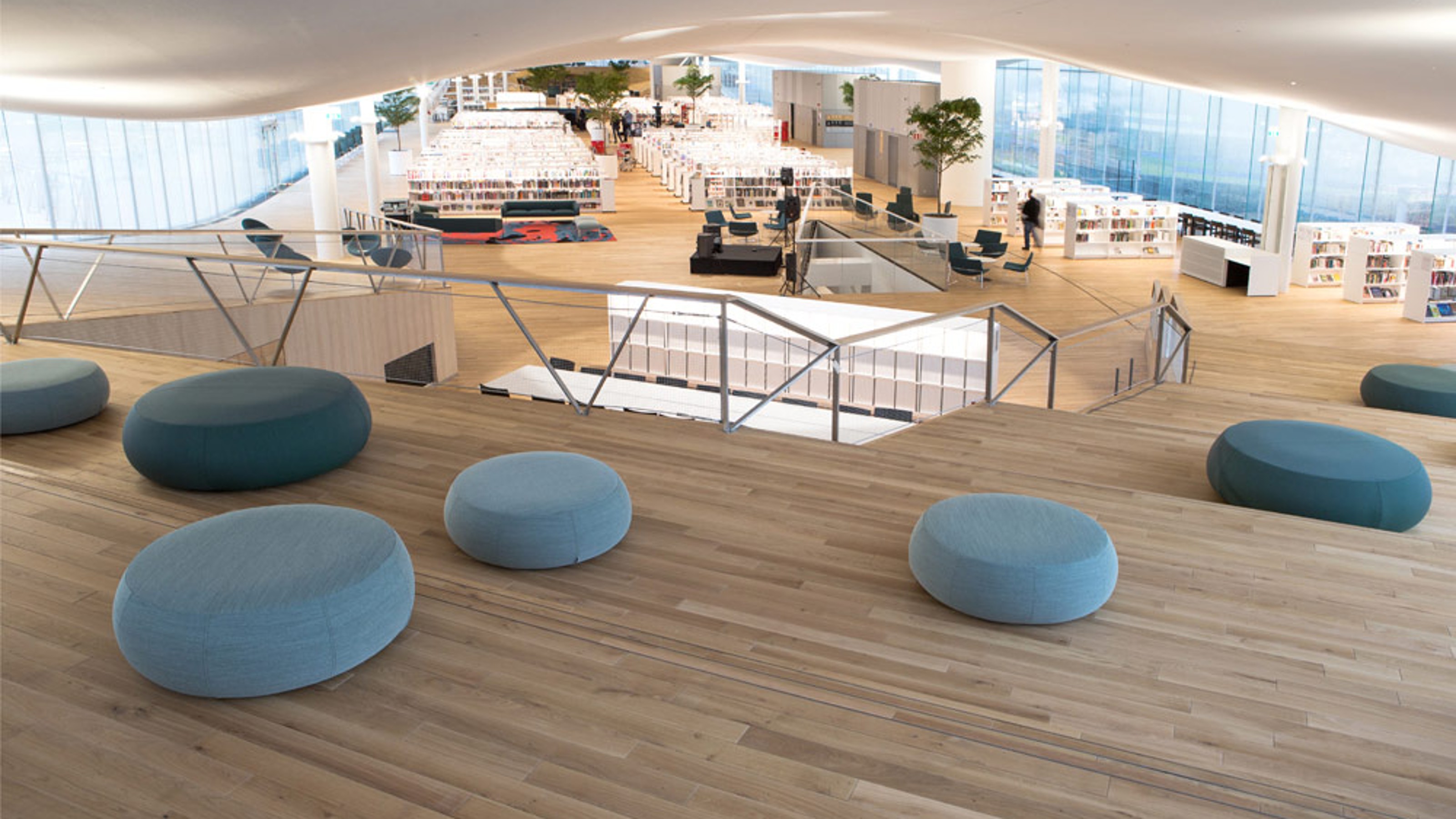 Oodi Central Library, seat cushions in the foreground with a view of the floor below with bookshelves and sofas