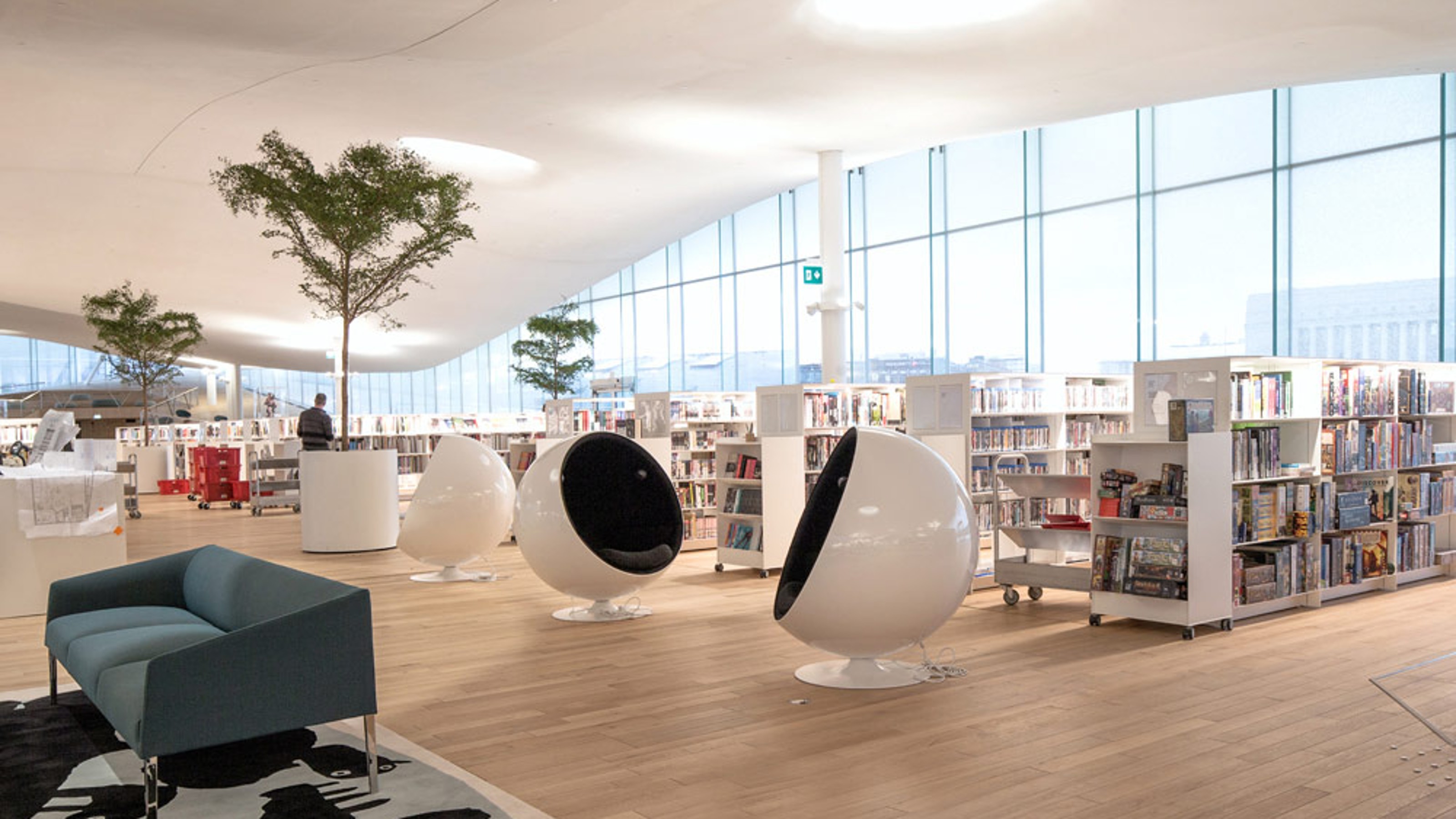 Oodi Central Library, bookshelves on the right, ball chairs in the centre, sofas on the left