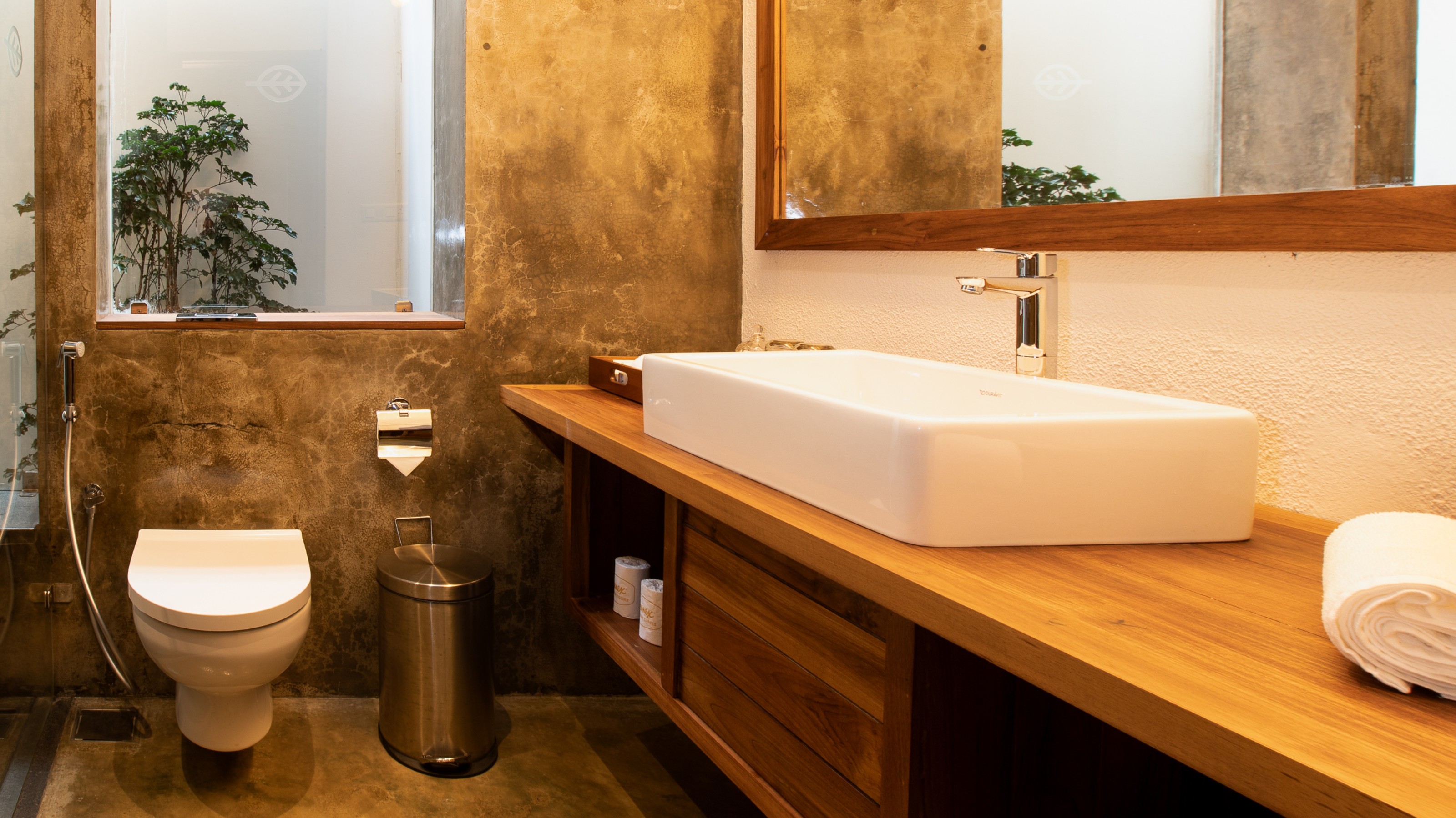 Prakriti Shakti Resort, bathroom with washbasin on wooden console on the right and toilet on the left