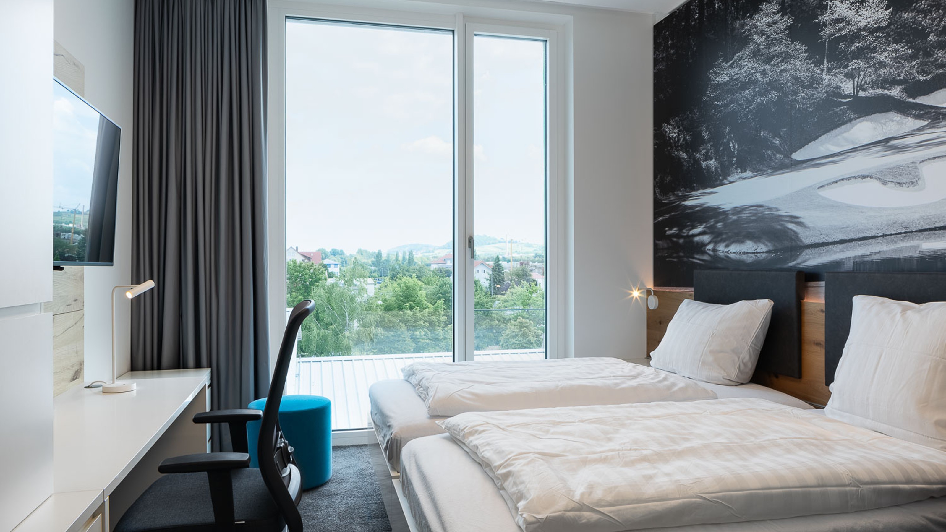 SLR Academy, room with bed on the right and desk on the left with view from the window
