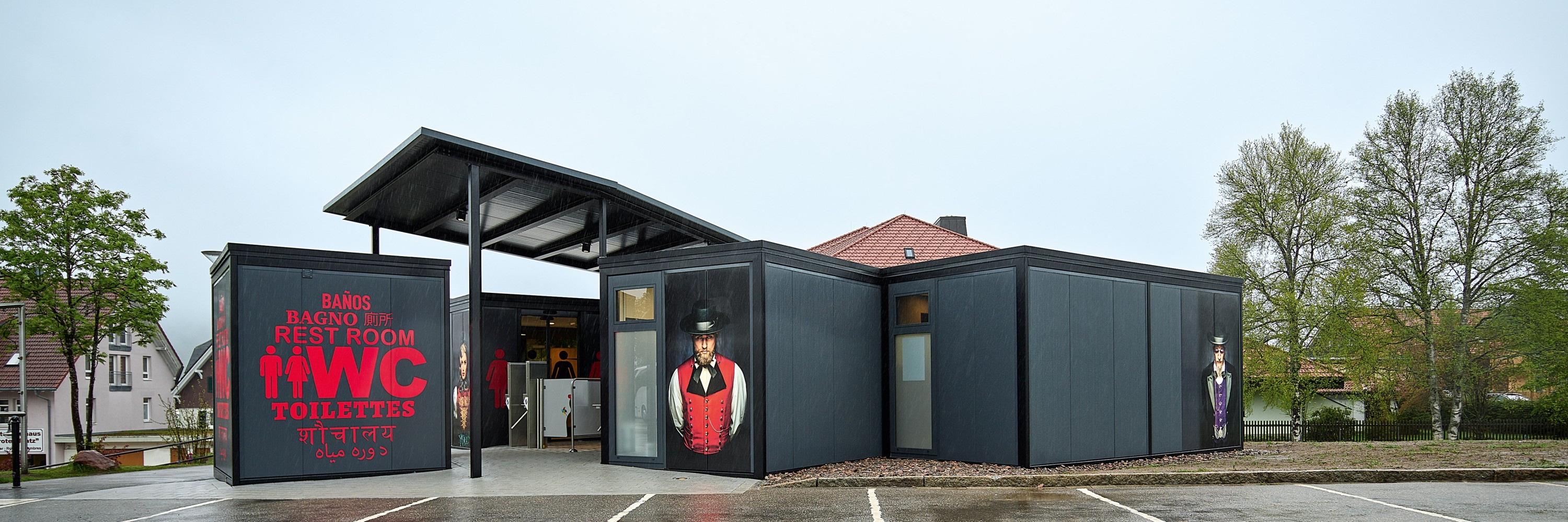 Titisee, toilet facilities from the outside, with portraits in local costume by renowned Black Forest photographer Sebastian