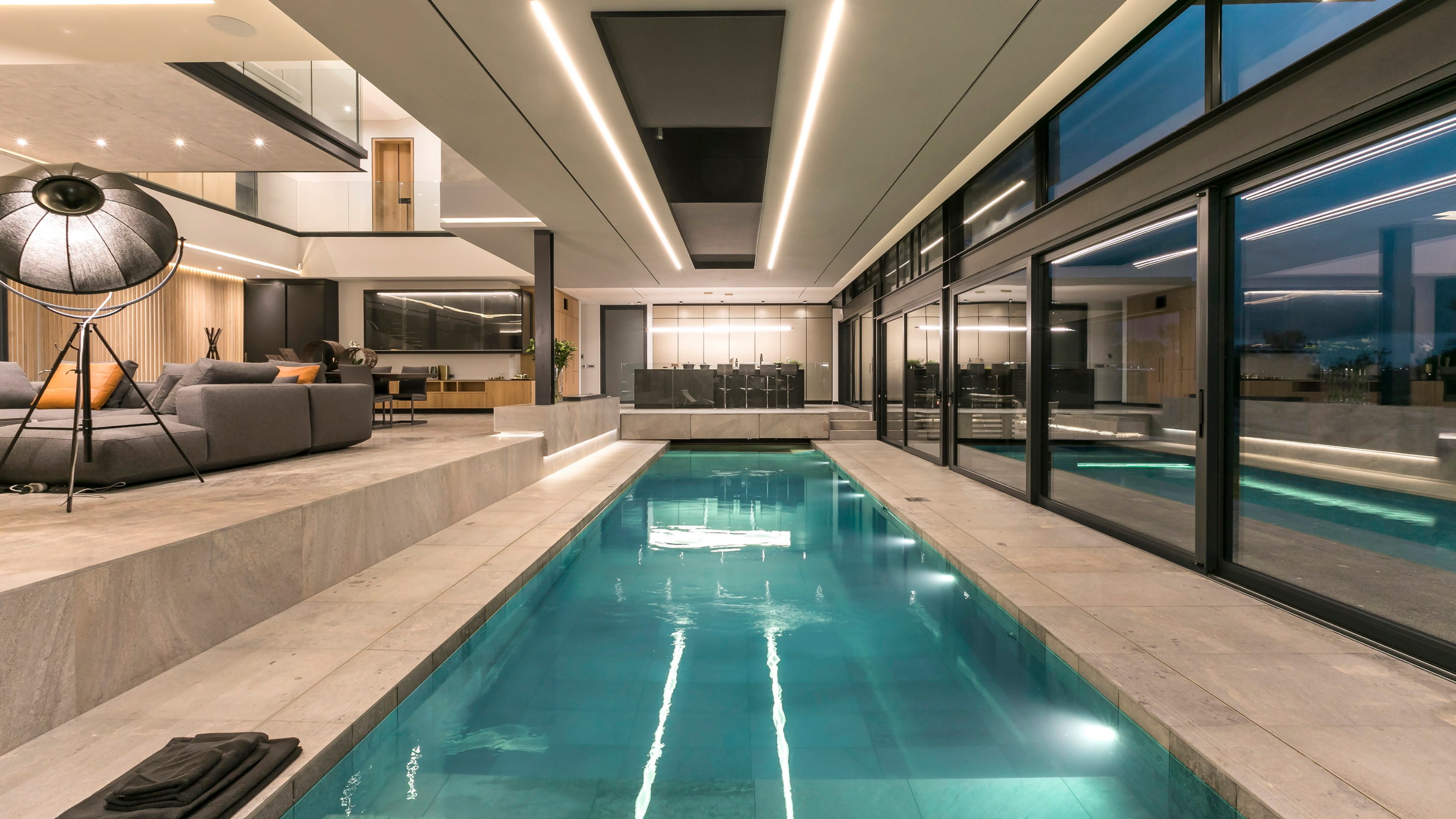 Victoria Residence, indoor pool in the foreground, living and dining area on the left