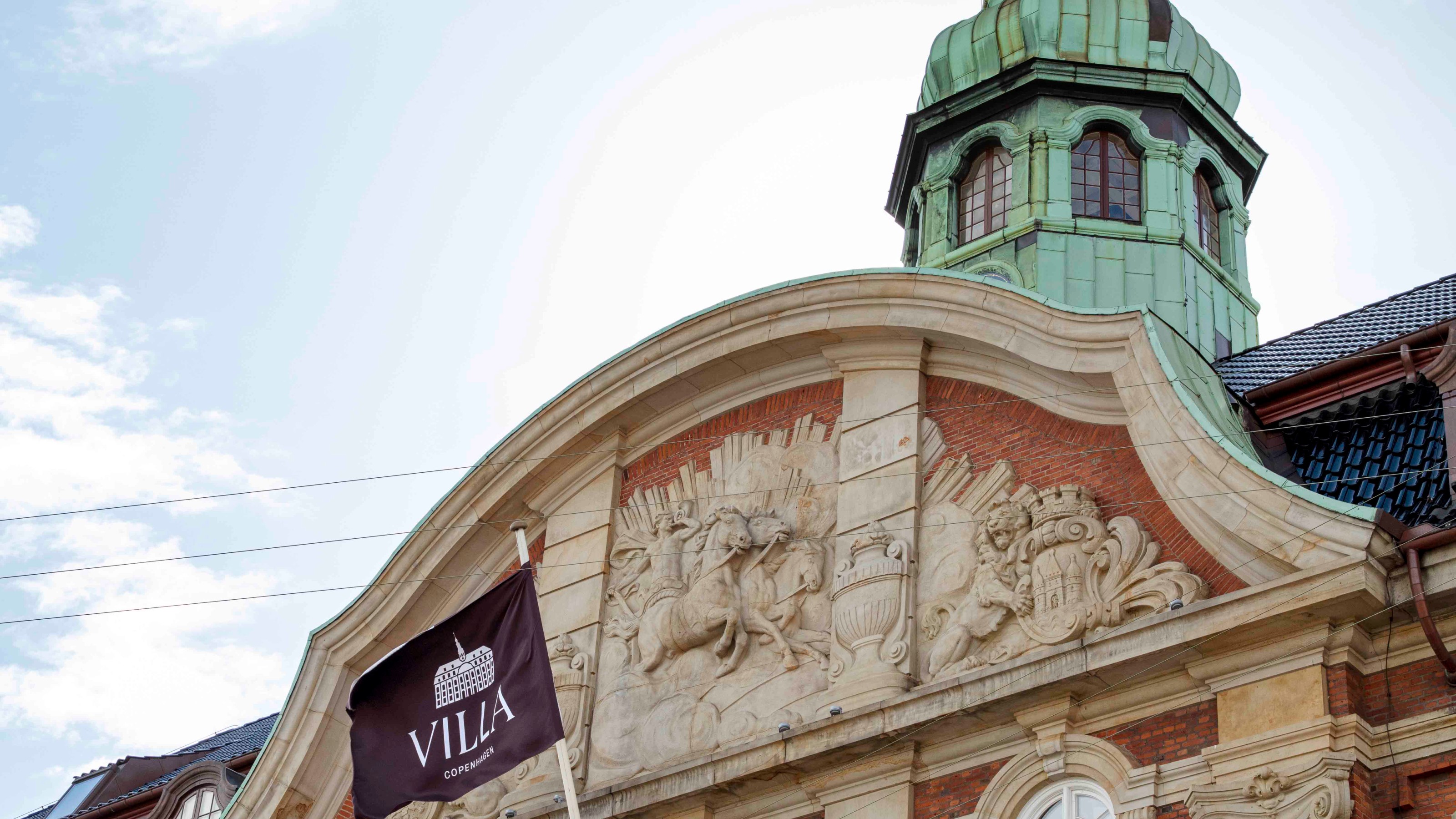 Villa Copenhagen, exterior view of the building with a flag flying