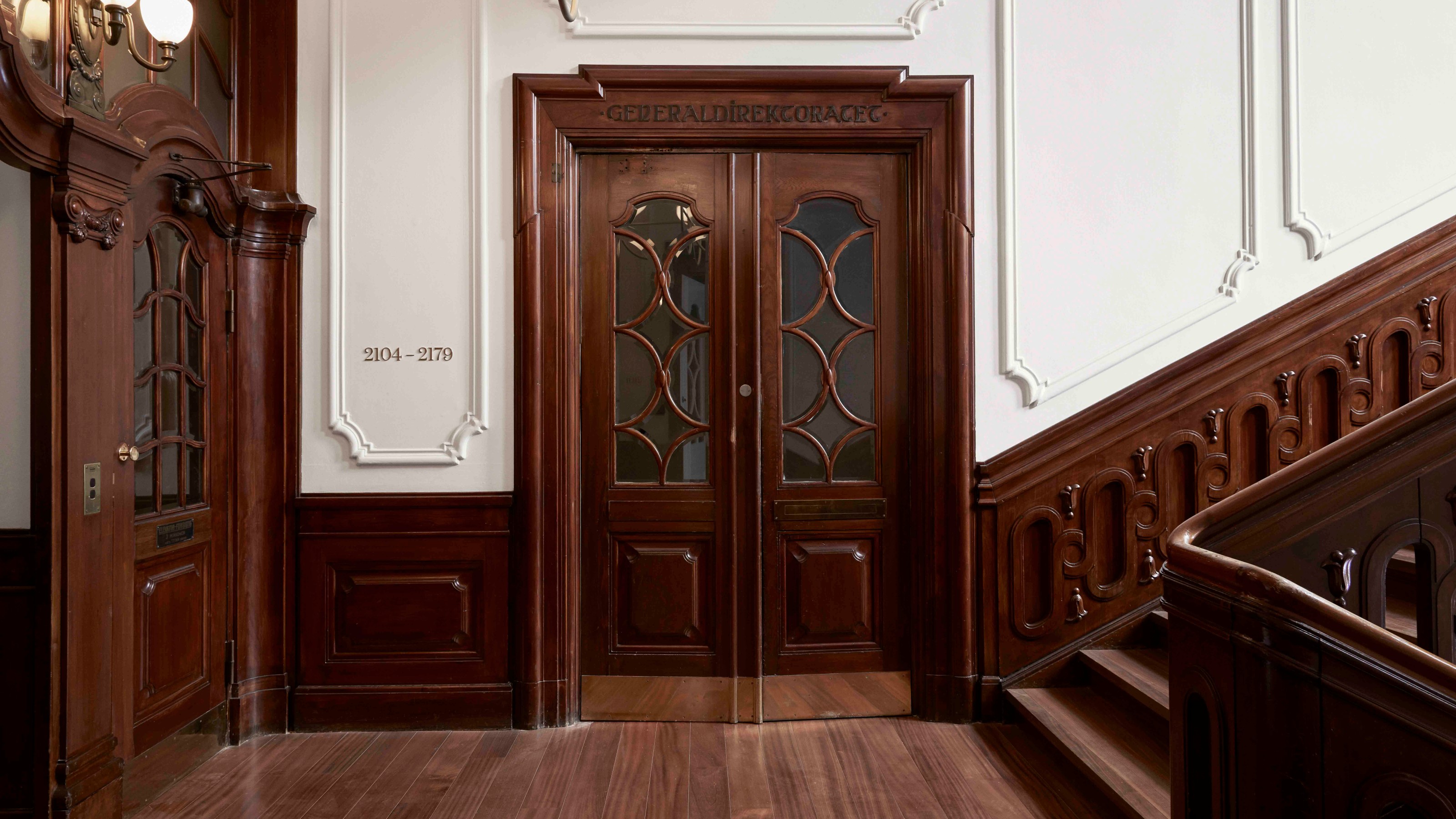 Villa Copenhagen, staircase, old wooden door in the centre and stairs on the right