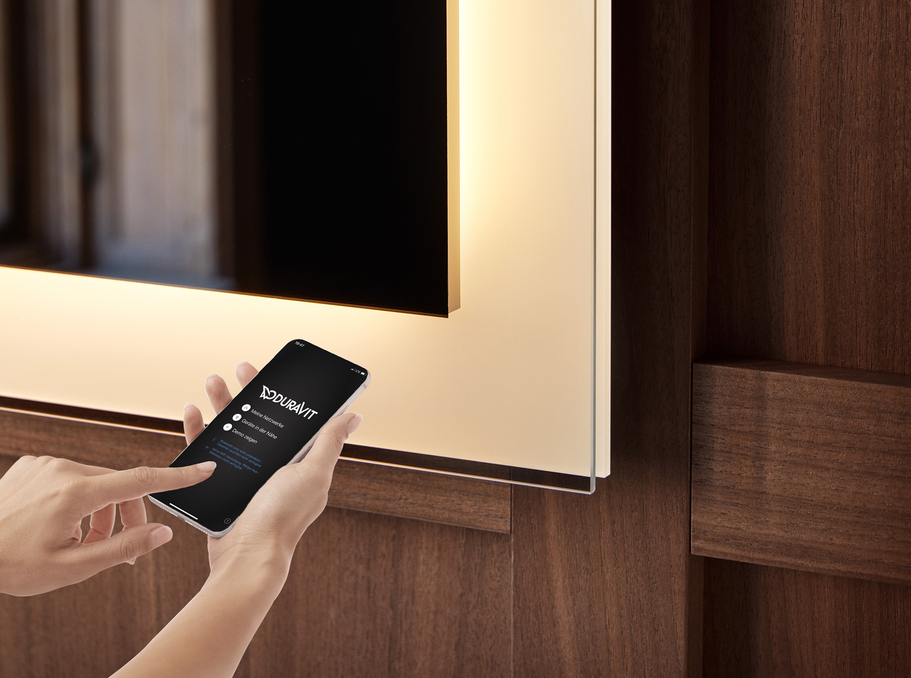 An illuminated mirror is controlled from a smartphone.